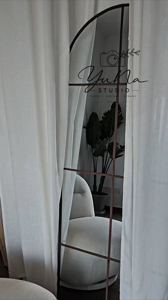 Arched mirror reflecting the studio